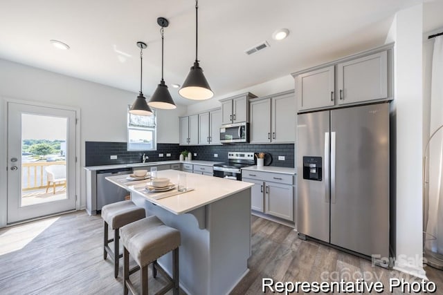 205 Cliffwood St NW Unit Unitb-2, Concord, NC 28027 - kitchen with appliances with stainless steel finishes, gray cabinetry, light wood-style floors, backsplash, and recessed lighting