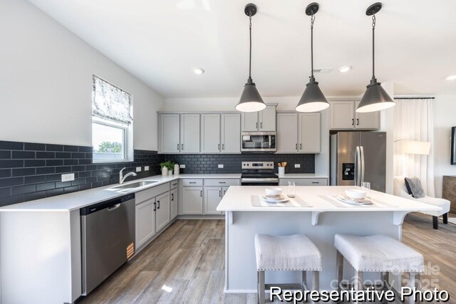 205 Cliffwood St NW Unit Unitb-2, Concord, NC 28027 - kitchen with stainless steel appliances, light countertops, light wood finished floors, a breakfast bar, and recessed lighting