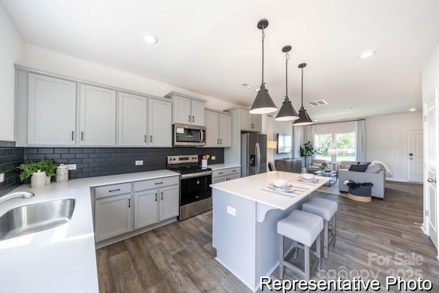 205 Cliffwood St NW Unit Unitb-2, Concord, NC 28027 - kitchen with appliances with stainless steel finishes, a kitchen breakfast bar, a kitchen island, wood finished floors, and recessed lighting
