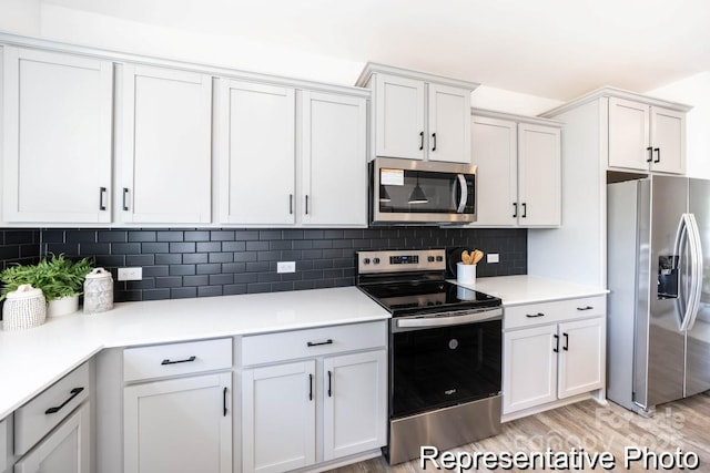 205 Cliffwood St NW Unit Unitb-2, Concord, NC 28027 - kitchen with appliances with stainless steel finishes, light wood-type flooring, white cabinetry, light countertops, and backsplash