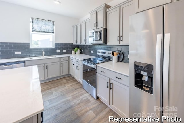 205 Cliffwood St NW Unit Unitb-2, Concord, NC 28027 - kitchen with stainless steel appliances, light countertops, decorative backsplash, and light wood-style flooring