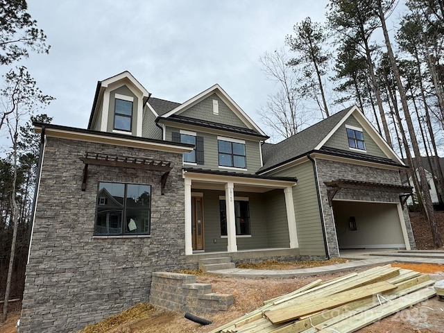 craftsman-style house featuring a garage and a porch