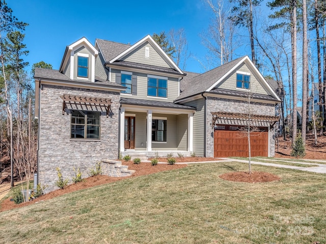 view of front facade with a porch, a front yard, a standing seam roof, metal roof, and stone siding