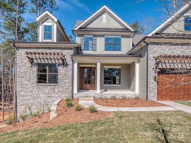 view of front of property featuring stone siding and covered porch