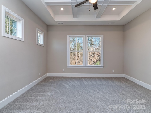 spare room with beam ceiling, coffered ceiling, visible vents, and baseboards