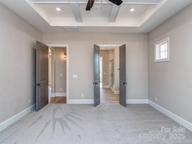 unfurnished bedroom with light carpet, coffered ceiling, and baseboards