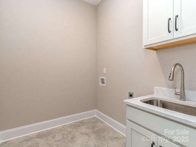 laundry area featuring cabinet space, baseboards, hookup for an electric dryer, washer hookup, and a sink