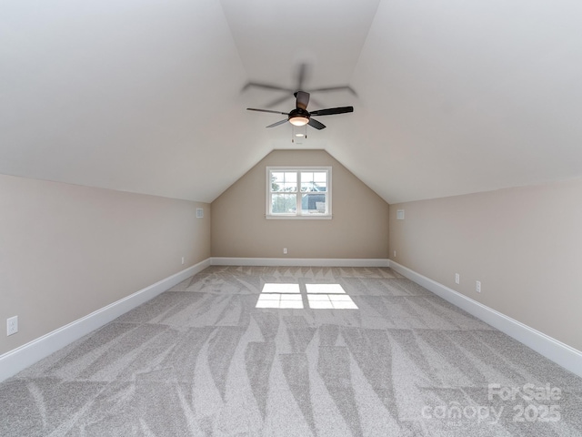 bonus room featuring light carpet, baseboards, vaulted ceiling, and a ceiling fan