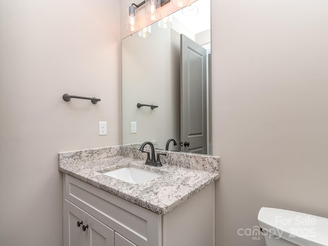 bathroom featuring toilet and vanity