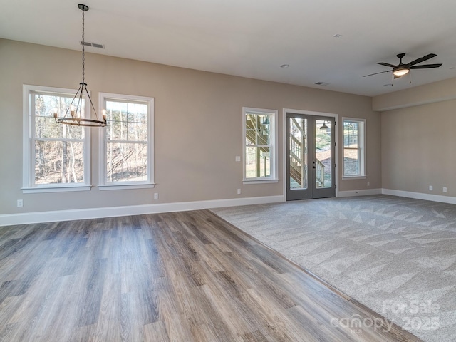 empty room featuring visible vents, baseboards, and a wealth of natural light