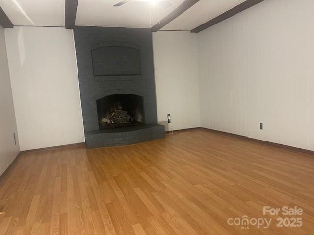 unfurnished living room featuring hardwood / wood-style floors and a fireplace