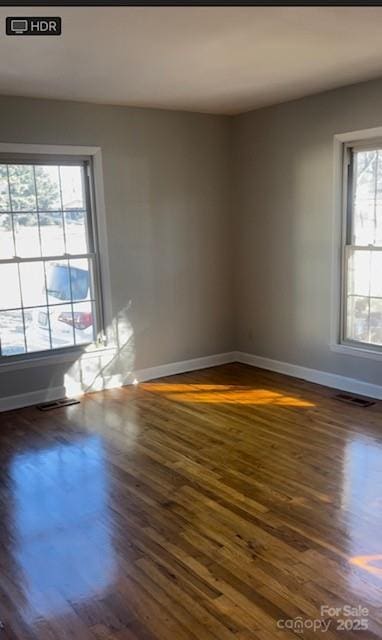 unfurnished room featuring dark wood-type flooring