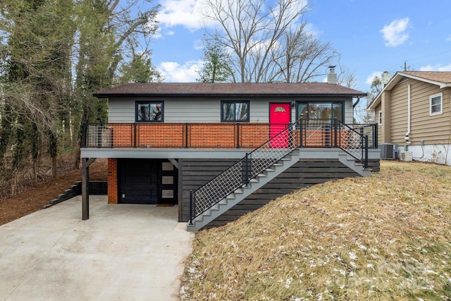 view of front of home with a carport and cooling unit