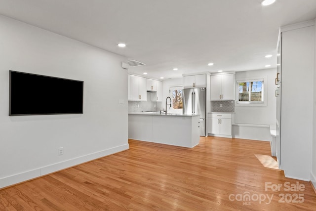 453 Riverview Dr, Asheville, NC 28806 - unfurnished living room featuring sink and light hardwood / wood-style floors