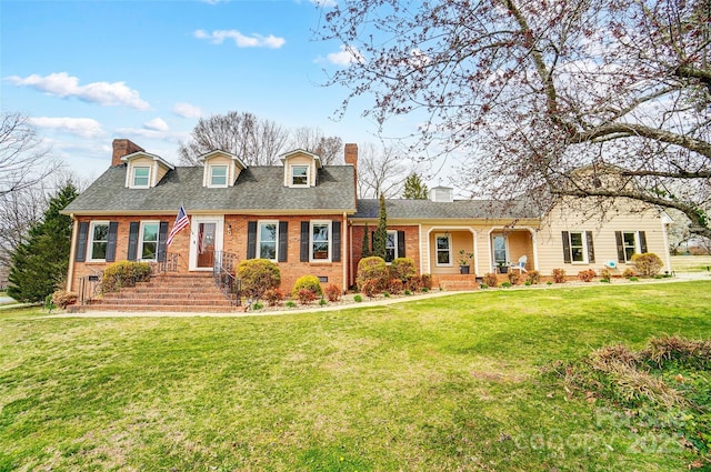 cape cod house with brick siding, a chimney, a front lawn, and a shingled roof