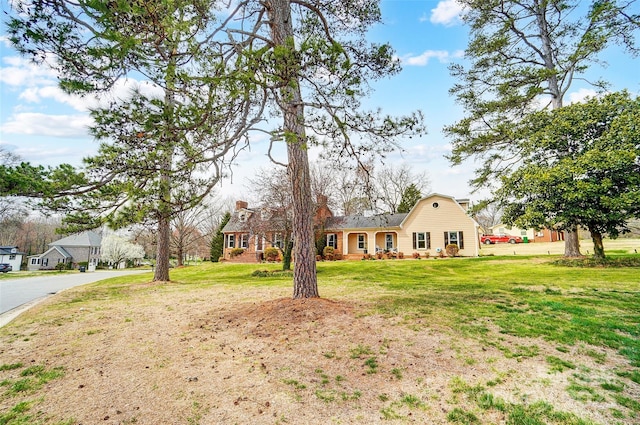 view of front of house with a front lawn and a chimney