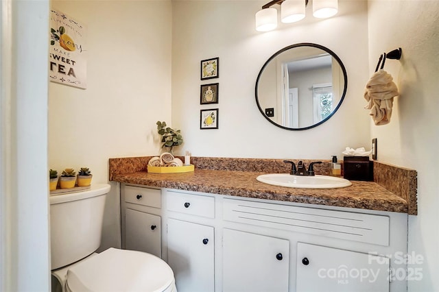 bathroom featuring vanity and toilet