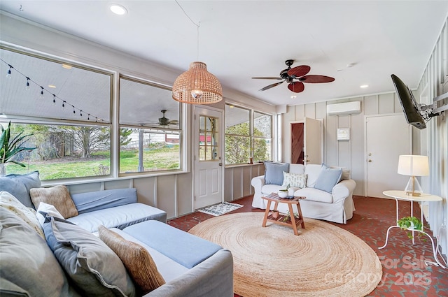 living area with an AC wall unit, recessed lighting, and a ceiling fan