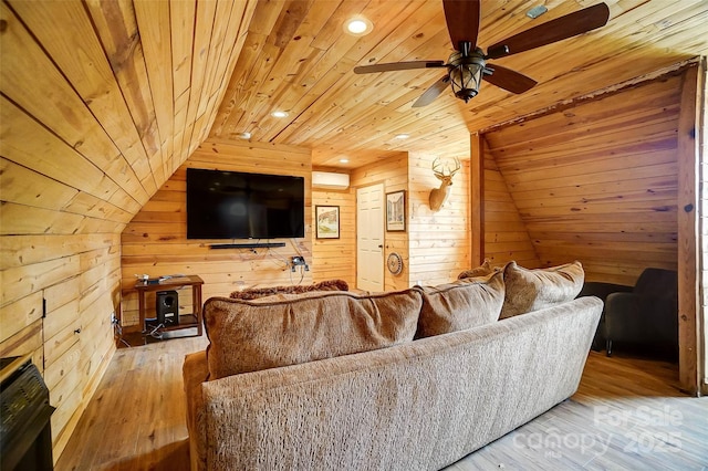 living area featuring hardwood / wood-style floors, wooden walls, ceiling fan, vaulted ceiling, and wooden ceiling