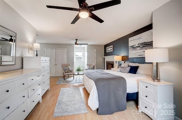 bedroom with light wood-style flooring and ceiling fan