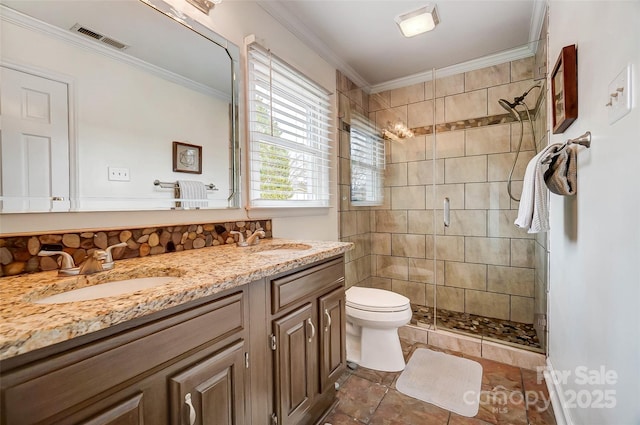 full bathroom featuring visible vents, a stall shower, a sink, ornamental molding, and toilet