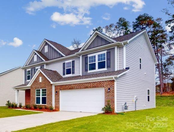 craftsman house featuring a garage and a front yard