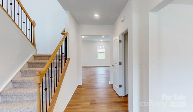 staircase with wood-type flooring