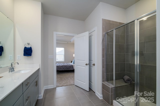 bathroom with an enclosed shower, vanity, and tile patterned floors