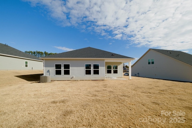 rear view of house featuring central air condition unit and a patio