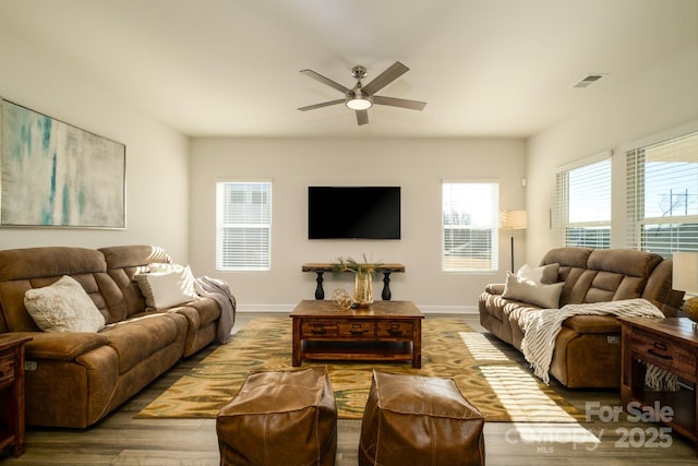 living room featuring ceiling fan and wood-type flooring