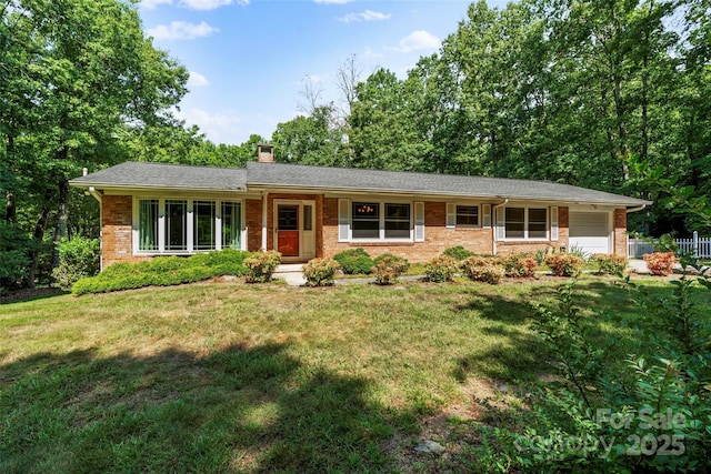 single story home with a front yard and a garage