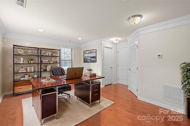 office space with ornamental molding and light hardwood / wood-style flooring