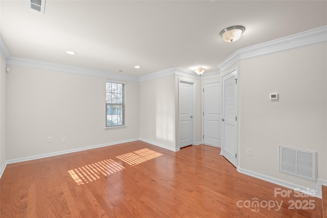 unfurnished room with crown molding and light hardwood / wood-style flooring