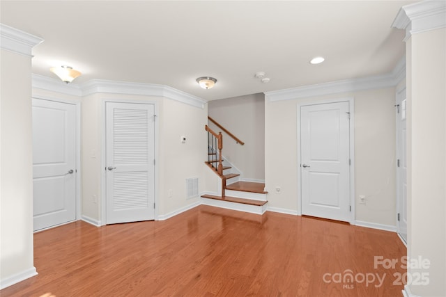 foyer featuring light hardwood / wood-style floors and crown molding