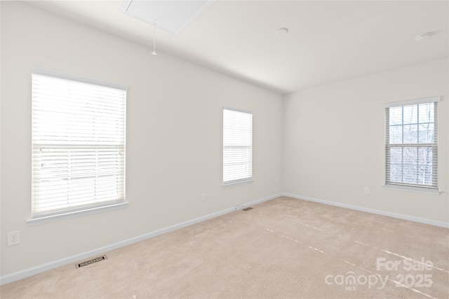 unfurnished room featuring light carpet