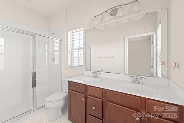 bathroom with toilet, vanity, tile patterned floors, and a shower with shower door