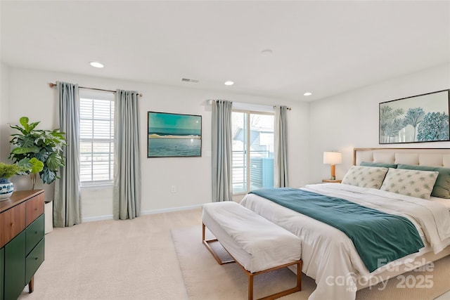 bedroom with light carpet and multiple windows