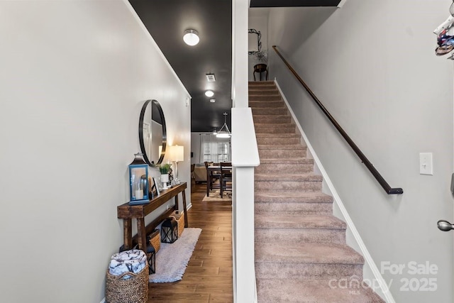 stairway featuring wood-type flooring