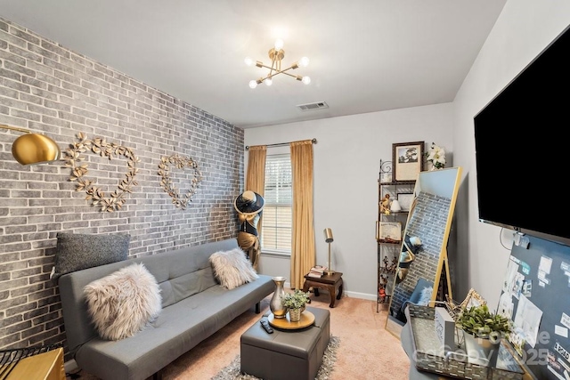 carpeted living room with brick wall and a chandelier