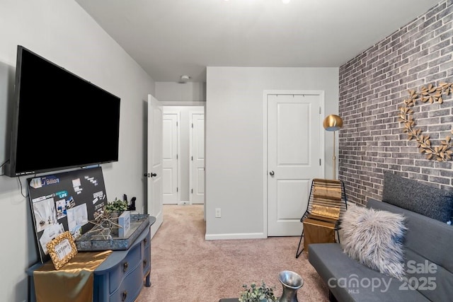 living room featuring brick wall and light colored carpet