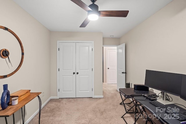 home office with light carpet and ceiling fan