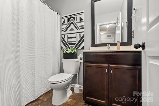 bathroom with toilet and vanity