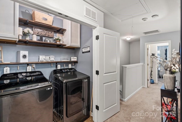 laundry room featuring light carpet, cabinets, and independent washer and dryer