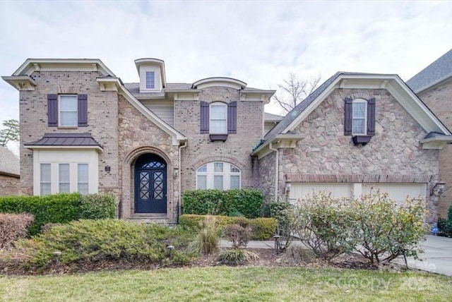 view of front of property featuring a front lawn and a garage