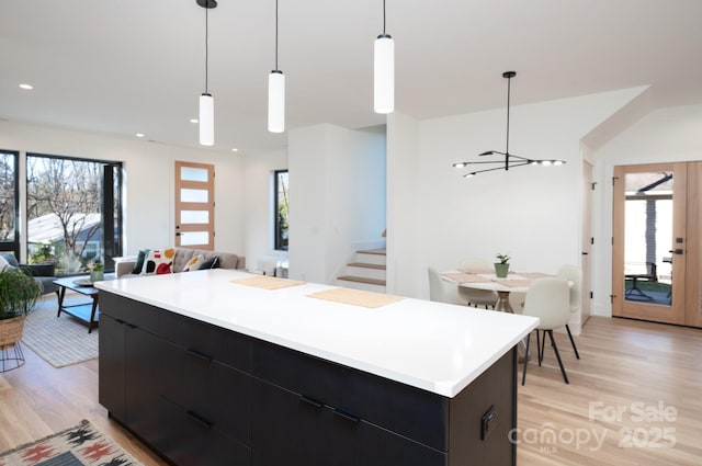 kitchen featuring a chandelier, light hardwood / wood-style floors, pendant lighting, and a center island