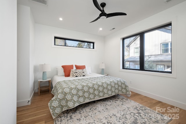 bedroom with ceiling fan and hardwood / wood-style flooring