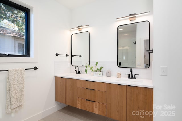 bathroom featuring vanity, tile patterned floors, and tasteful backsplash