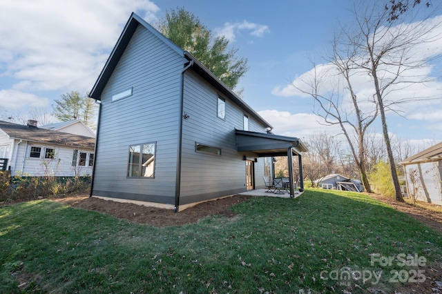 rear view of house with a patio area and a yard