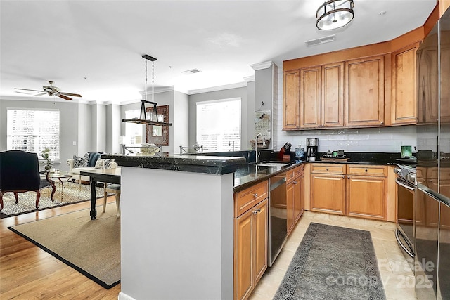 kitchen featuring dishwasher, crown molding, kitchen peninsula, pendant lighting, and sink