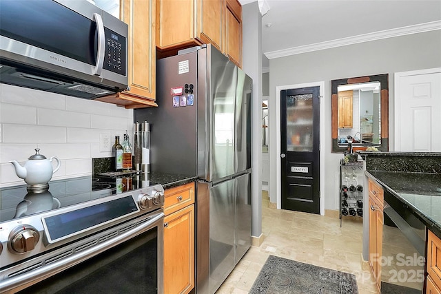 kitchen featuring dark stone countertops, tasteful backsplash, crown molding, and appliances with stainless steel finishes